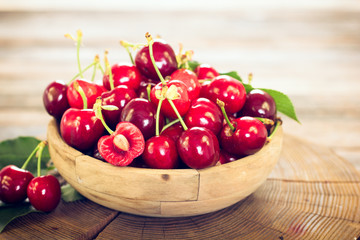 Fresh cherries in the wooden bowl
