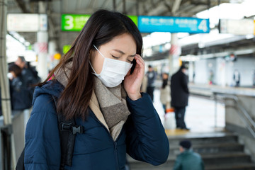 Woman feeling dizzy at train platform