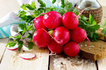 Radishes fresh bun, bread and salt on a wooden table. © elena_hramowa