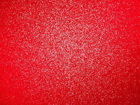 festive sparkling red glitter background texture with a highlight in the center (3D illustration)