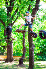 Fototapeta premium adventure climbing high wire park - people on course in mountain