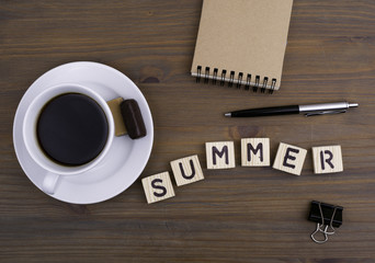 Coffee cup on a wooden table and text -  Summer