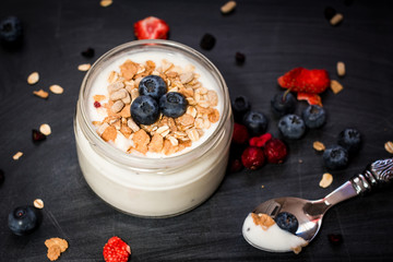 Healthy breakfast - yogurt with blueberries and muesli served in bank