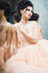 Fototapeta premium Portrait of beautiful young brunette woman in gorgeous fashionable dress