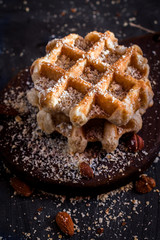 Belgian sugar waffles with grated nuts and caramel syrup