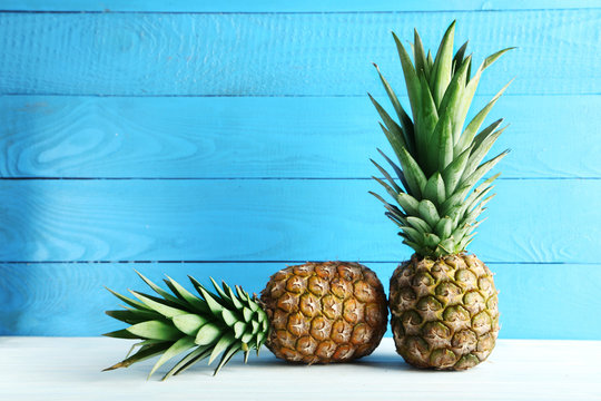 Ripe pineapples on a white wooden table