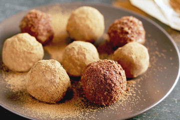 Sweet chocolate truffle on a black wooden table