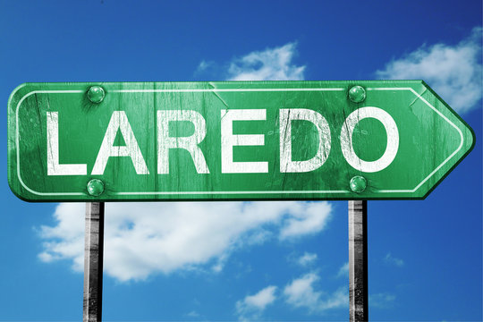 laredo road sign , worn and damaged look