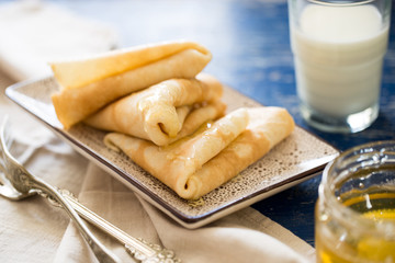 Crepes. Russian thin pancakes with honey. Breakfast table.