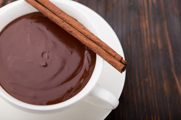 Cup of hot chocolate with cinnamon stick