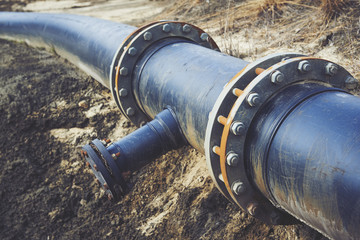 Steal big pipeline on a ground. Old pipes joint.

