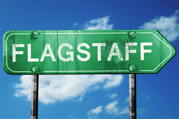 flagstaff road sign , worn and damaged look