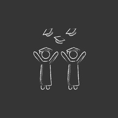 Graduates throwing caps. Drawn in chalk icon.
