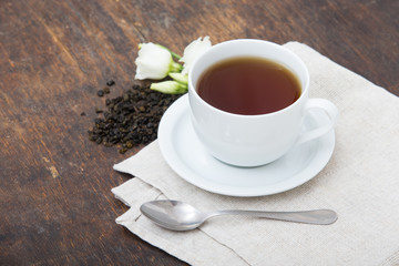 Closeup of cup of tea on vintage wooden background