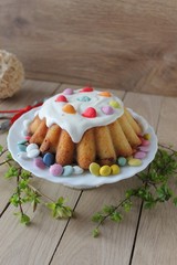 cupcake with white frosting and candies