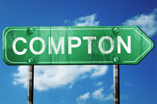 compton road sign , worn and damaged look