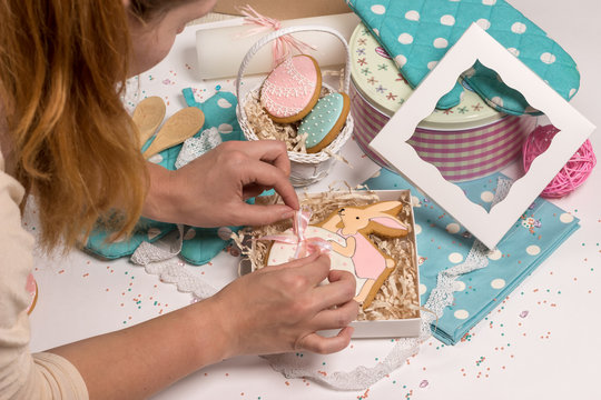 girl puts easter rabbit gingerbread, holiday present preparations, kitchen design