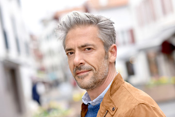 Fototapeta premium Portrait of mature handsome man in town