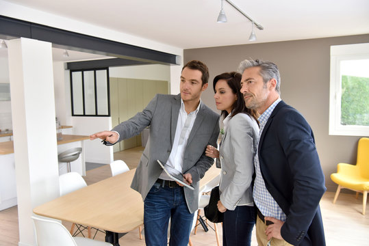 Mature couple with real-estate agent visiting new house