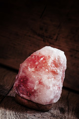 Salt lamps of pink Himalayan salt, vintage wooden background, se