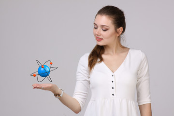 Woman scientist with atom model, research concept