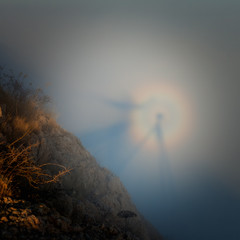 Silhouette of a man with a rainbow in the clouds