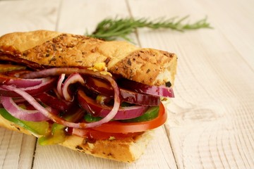 Obraz premium sandwiches with salad, onion, salami, pepperoni, ham, cheese and