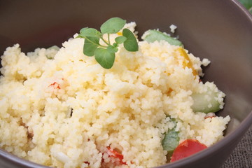 Couscous and roasted vegetables salad in a brown dish