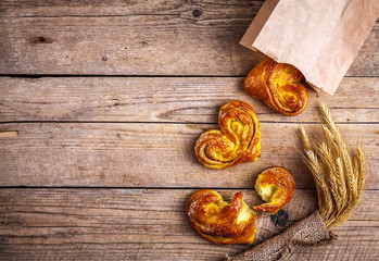 Delicious Breakfast, a pretzel with coffee on wooden background.
