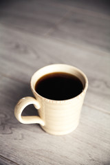 cup of coffee on gray wood