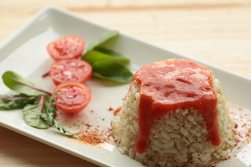 Cuban style rice on a white plate elongated