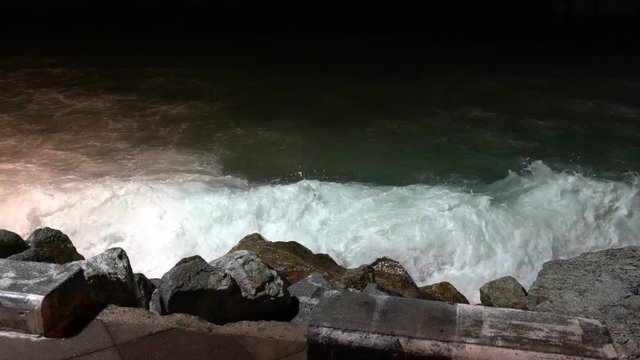Big sea waves beating against the coastal rocks. Big splashes of the ocean waves crashing on the rocks