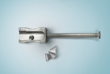 Nail and sharpener. Creative concept