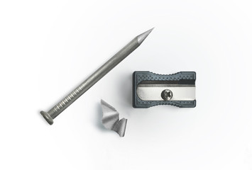 Nail and sharpener on a white background. Creative concept