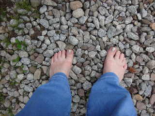Woman's legs on the ground in summer day