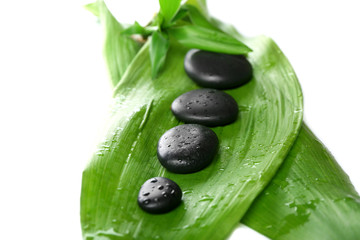 Fototapeta na wymiar Hot spa stones with bamboo, isolated on white