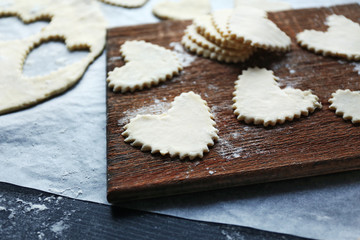 Uncooked heart shaped biscuits on a table