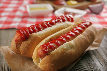 Hot dogs on wooden background closeup