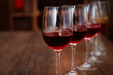Many glasses of different wine in a row on bar counter
