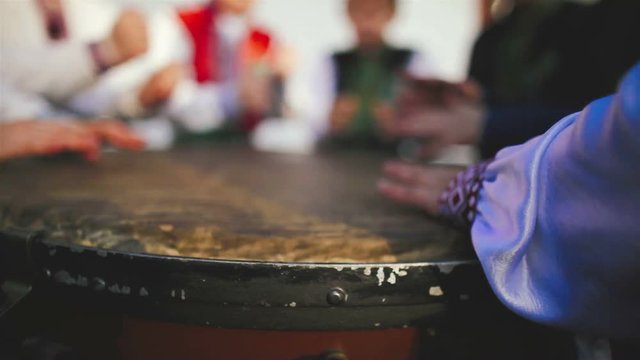 Drummer hand performing on the ethnic drum close up