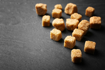 Pile of brown sugar cubes on the table
