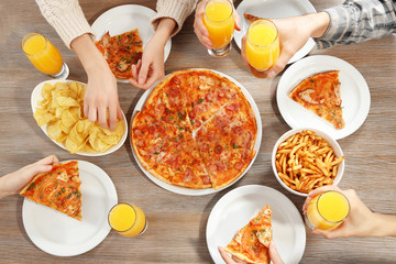 Friendly party with hot pizza and drinks, close up