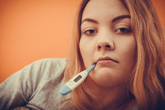 Sick Ill Woman With Digital Thermometer In Mouth.