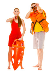 Lifeguards in life vest with rescue buoy whistling