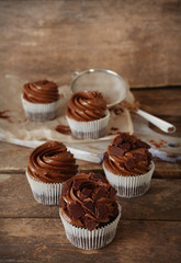 Chocolate cupcakes on wooden background