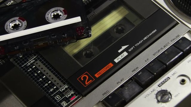 Pushing a Finger Play and Stop Button on a Two Decks Tape Recorder