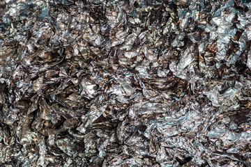 Wrinkled and charred aluminum foil