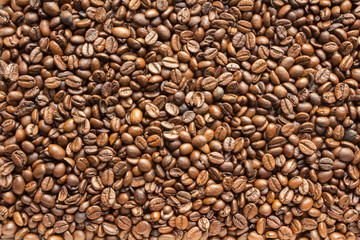 the texture of the coffee beans roasted Brown background