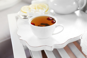 Obraz na płótnie Canvas White tea set on a wooden tray on table