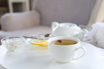 Tea set on a white wooden tray